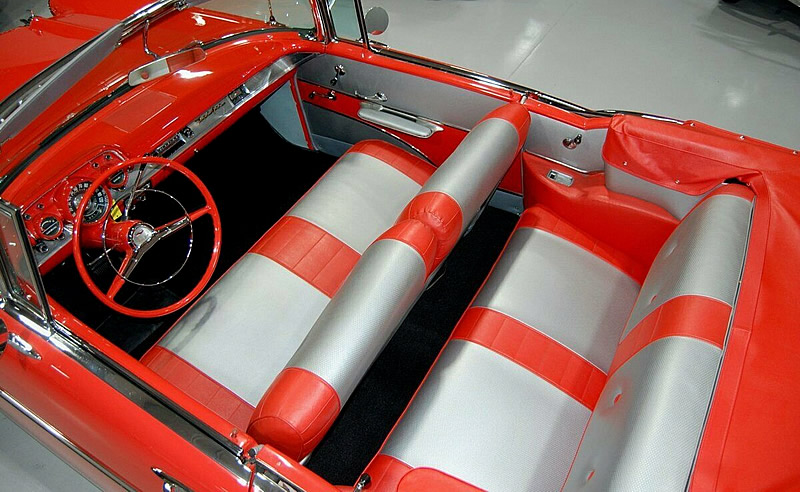 red and silver vinyl interior of a 57 Chevy convertible