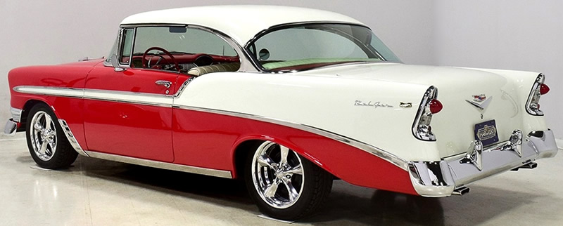 rear view of a 56 Chevy restomod in red / white