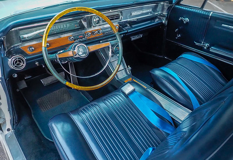 Interior shot of a very nice 1964 Pontiac Grand Prix - dark blue bucket seats