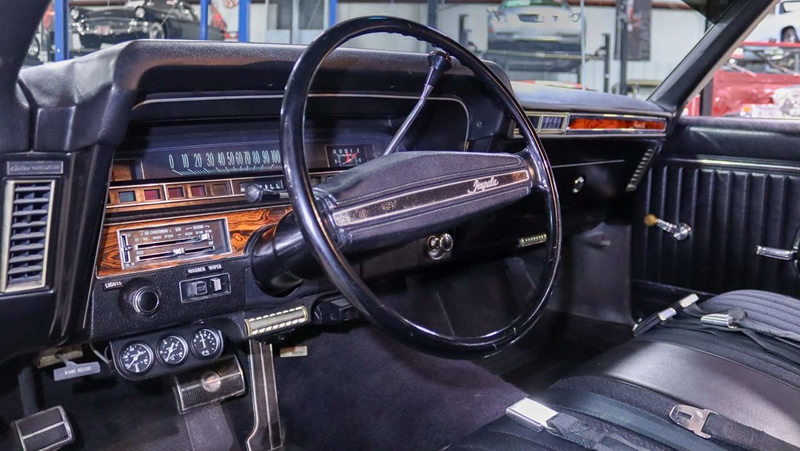 black cloth and vinyl bench seat interior of a 1969 Impala