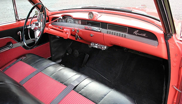 Coral/pink striped broadcloth and black vinyl interior of a 54 Plymouth