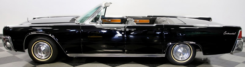side view of a 62 Lincoln Continental  convertible with the top down